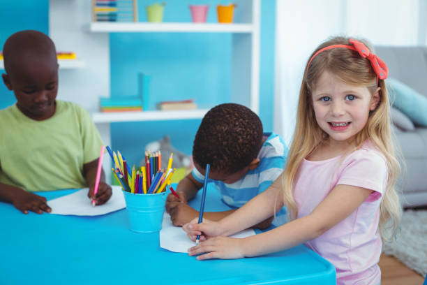 istock Happy kids enjoying arts and crafts together 664246712