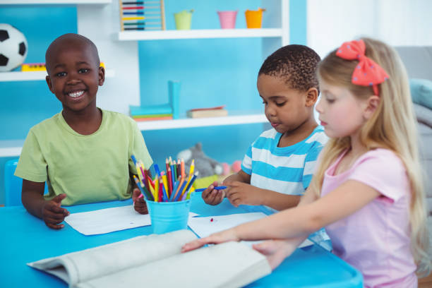 istock Happy kids enjoying arts and crafts together 664246862