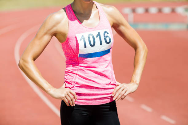 istock Mid section of female athlete standing with hands on hips 664247172