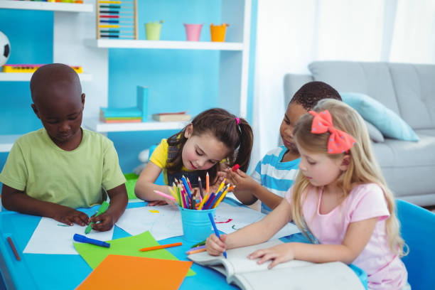 istock Happy kids enjoying arts and crafts together 664247594