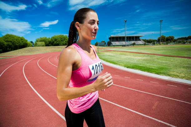 istock Female athlete running on the running track 664249756