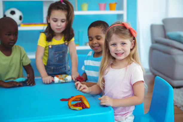 istock Happy kids enjoying arts and crafts together 664250092