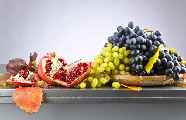 istock blue and green grapes with pomegranate 664253614