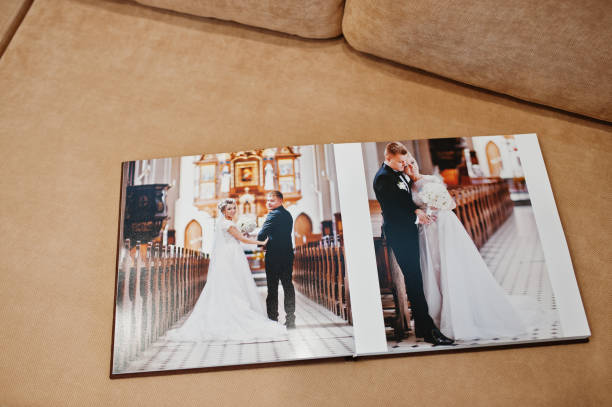 istock Two open pages of wedding book on sofa. 664253634