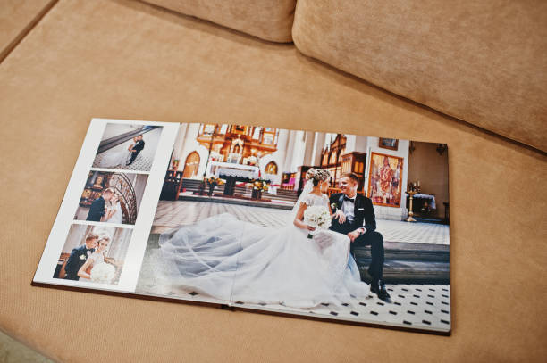istock Two open pages of wedding book on sofa. 664253708