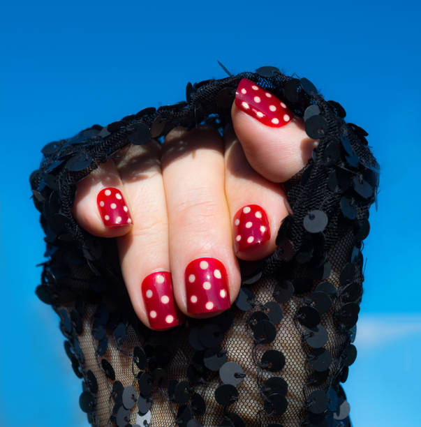 istock Short red white polka dot nails in in sequin sleve 664253742