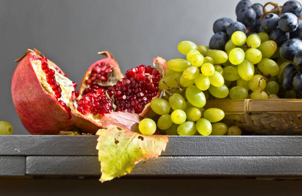 istock blue and green grapes with pomegranate 664254346
