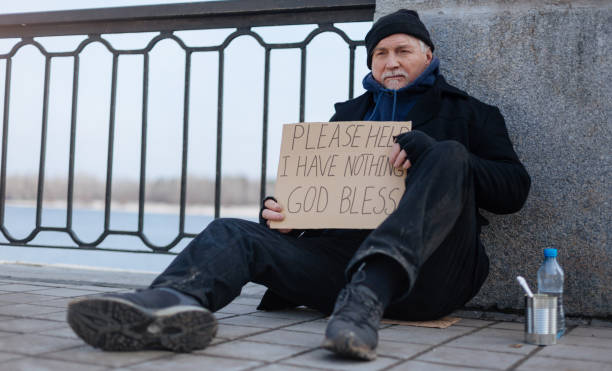 istock Jobless elderly man sitting on the cardboard box 664255120