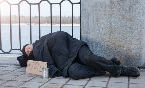 istock Untidy man sleeping in the street 664255578
