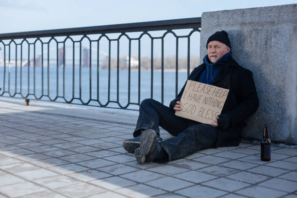 istock Poor man sitting near glass bottle 664259186