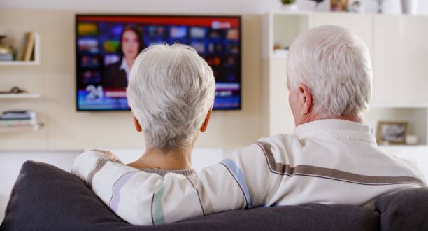 istock Senior couple watching TV 664259296