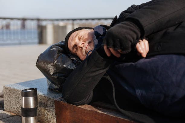 istock Sleepy man lying on the bench 664259462