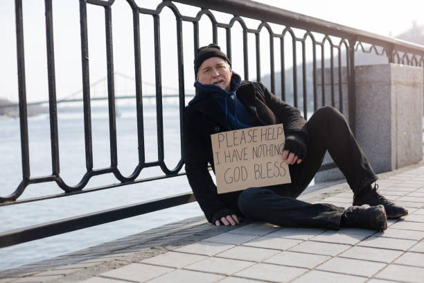 istock Poor male person holding cardboard in left hand 664259542