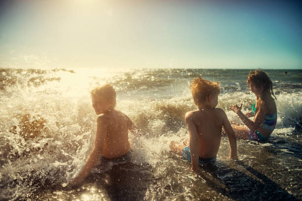 istock Kids splashing in the mediterranean sea 664266356