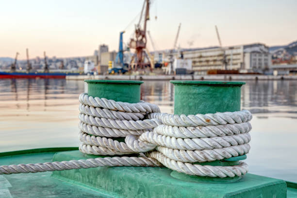 istock Old mooring bollard with heavy ropes 664266434