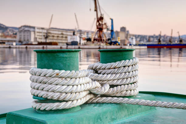 istock Old mooring bollard with heavy ropes 664267032