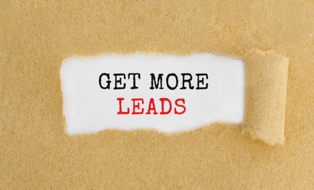 istock Get More Leads appearing behind ripped brown paper. 664268676