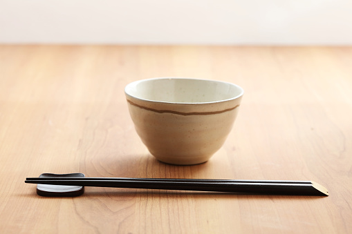 Chopsticks on a white bowl