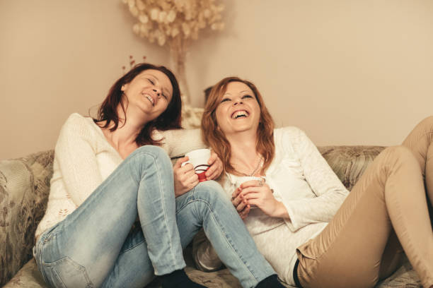 istock sisters at home drinking coffee, laughing and enjoying the moment 664281062