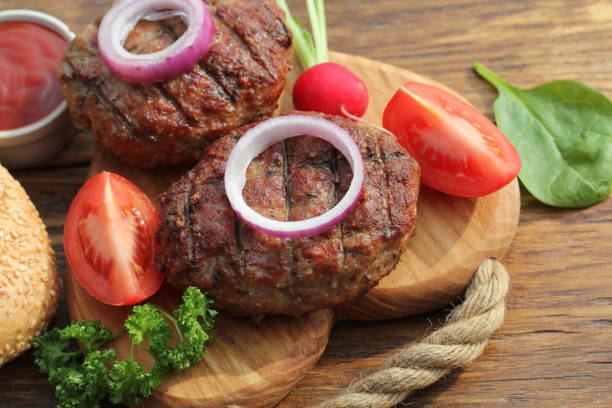 istock beef burger with onion and sauce on cutting board 664287786