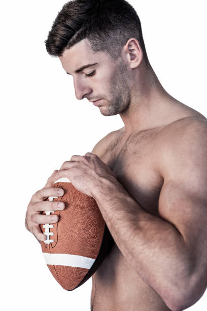 istock Rugby player holding the ball while looking down 664296060