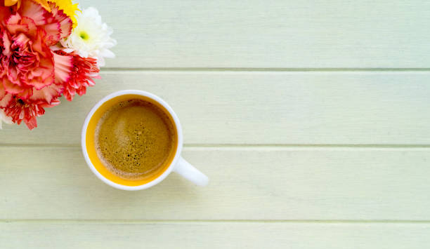 istock A cup of coffee and red flower 664297512