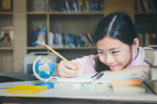 istock Education Concept. School girl reading book in library. 664307560
