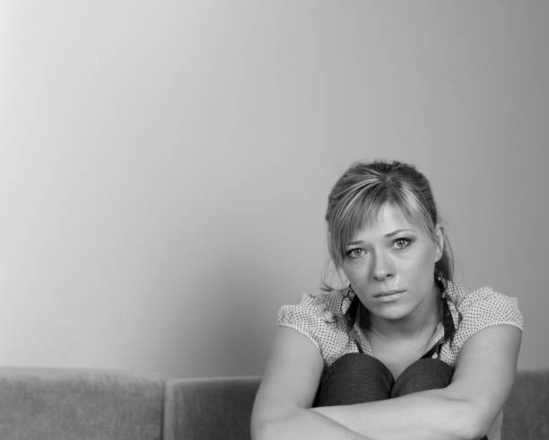 istock Woman Suffering From Depression Sitting On Bed And Crying 664309192