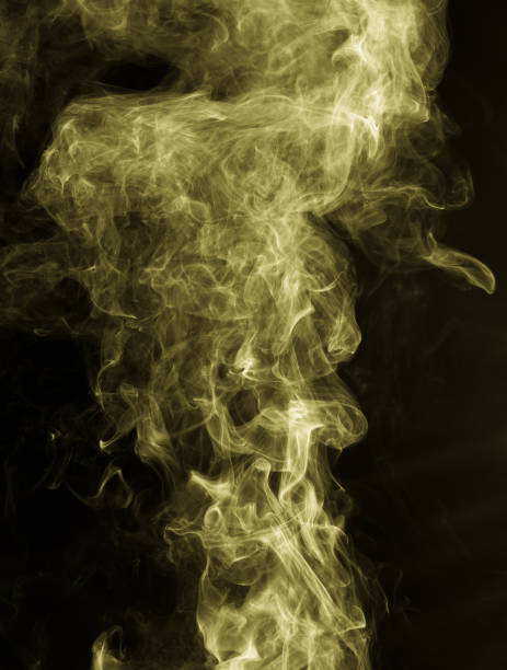 istock Yellow smoke against a black background 664312658