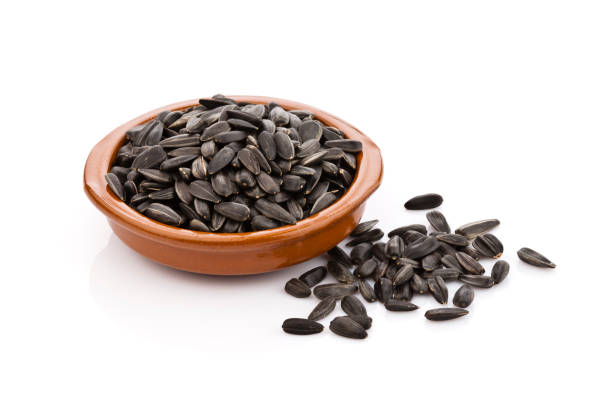 istock Sunflower seeds in a brown bowl 664313700