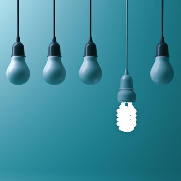 istock One hanging energy saving light bulb glowing different stand out from unlit incandescent bulbs with reflection on dark cyan background , leadership and different creative idea concept. 3D render 664317660