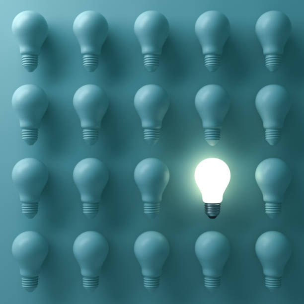 istock One glowing light bulb standing out from the unlit incandescent bulbs on green background with reflection , individuality and different creative business bright idea concepts . 3D render 664317730