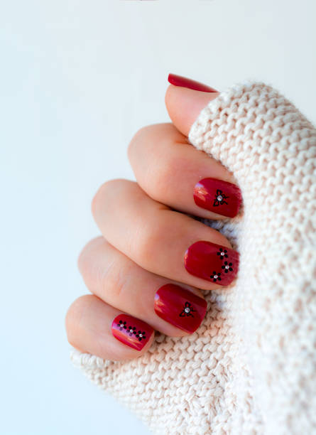 istock Short red butterfly flower nails in in sequin white knitted sleve 664322132