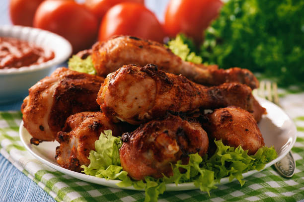 istock Baked chicken drumsticks with tomato dip. 664324956
