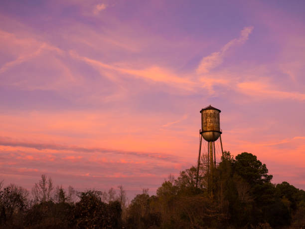 istock Old Small Town Water Tower Against a Brilliant Sunset Sky 664325808