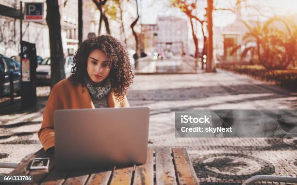 Beautiful Curly Lady With Laptop In Street Bar Stock Photo - Download Image Now - Remote Location, Portugal, Business