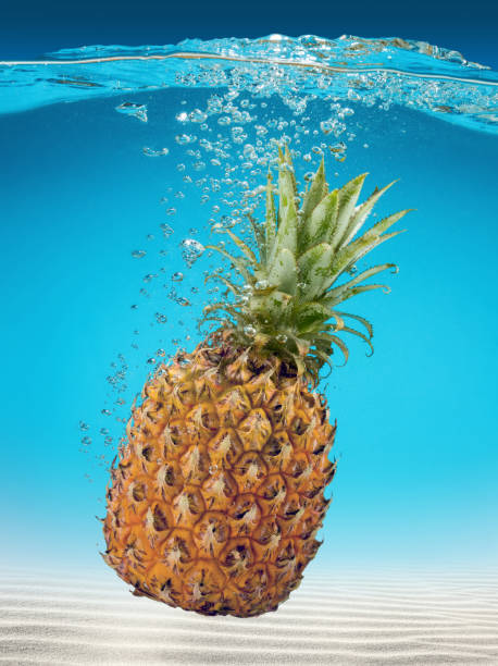 istock ripe pineapple falling into sea water 664336658
