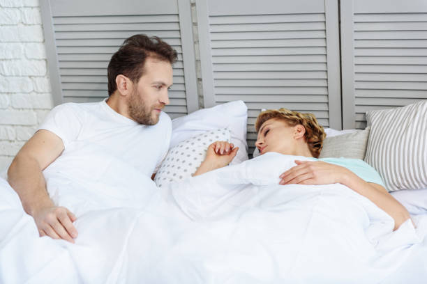 istock Careful man watching his woman sleeping 664337030