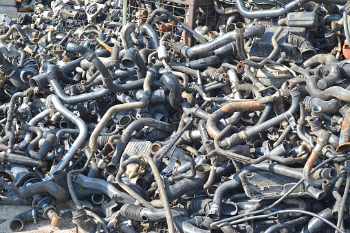 a pile of old car engine pipes