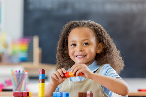 istock Confident little girl plays with counting blocks 664349168
