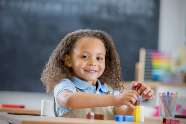 istock Happy girl counts blocks in kindergarten class 664349184