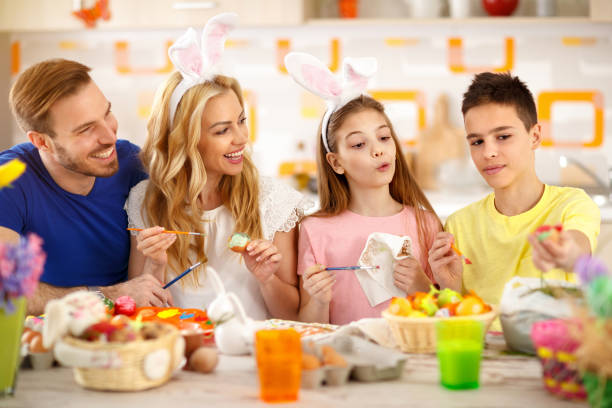 istock Happy family together coloring Easter eggs 664349654