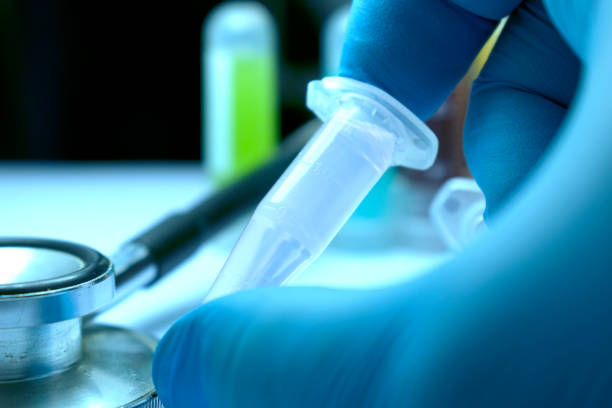 istock Gloved Hand Holding Research Vial 664349744