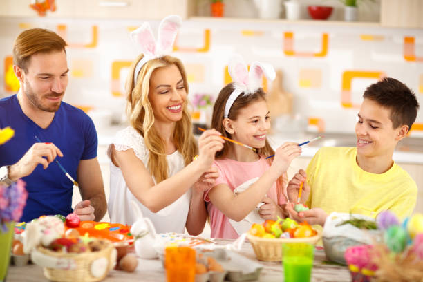 istock Family together painting Easter eggs 664349972