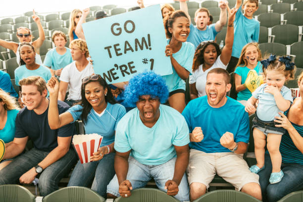 istock Crowd of fans cheering from stadium bleachers 664352960