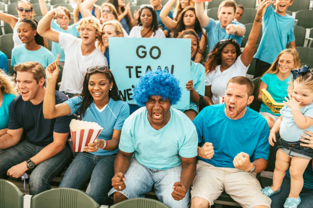 istock Crowd of fans cheering from stadium bleachers 664352966