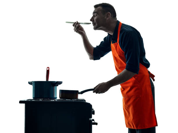 istock man cooking chef silhouette isolated 664353060