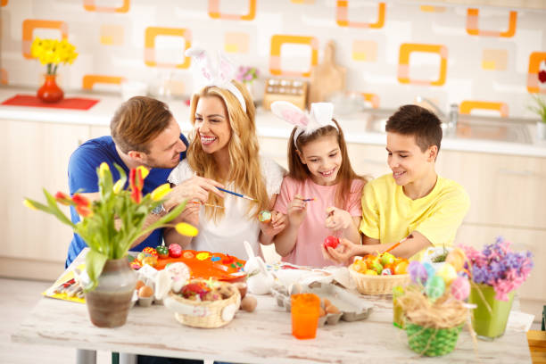 istock Family together coloring Easter eggs 664353412