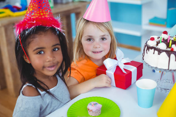 istock Excited kids enjoying a birthday party 664359742