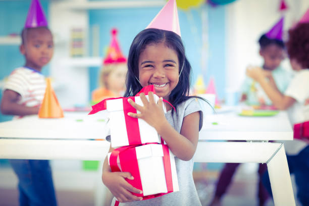 istock Smiling girl at birthday party 664363544